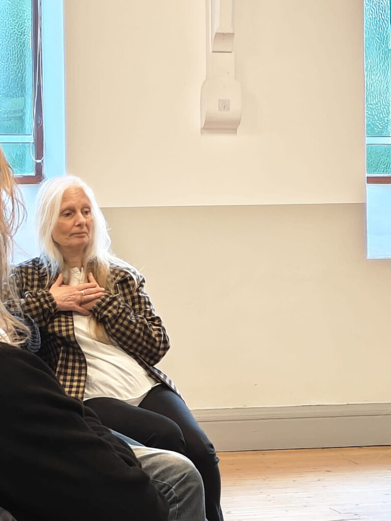 Deputy Leader of Wales Green Party Linda Rogers sat with hands on chest in middle of Nuclear Discussion